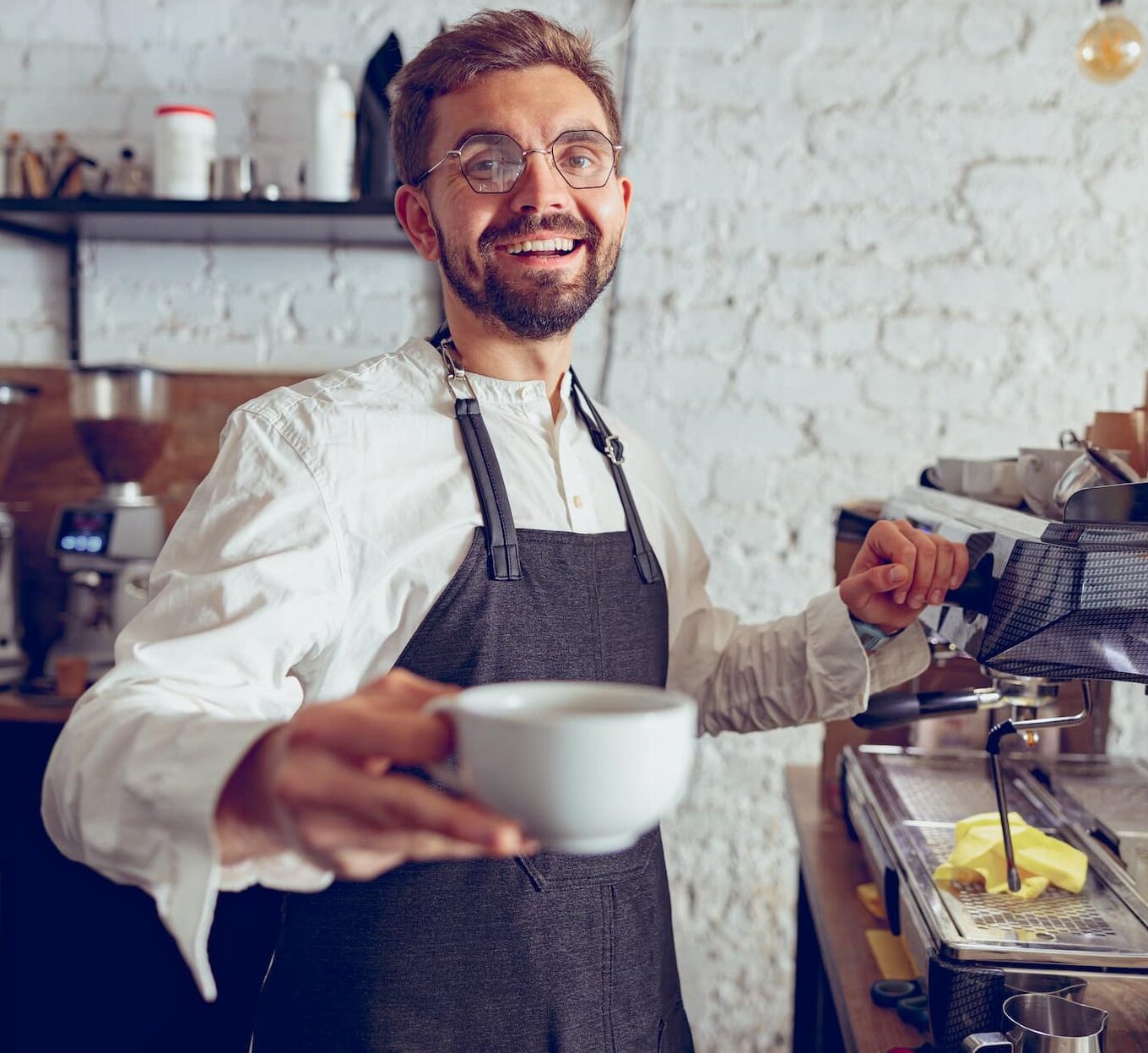 Barista serving coffee at Pearl Lemon Cafe