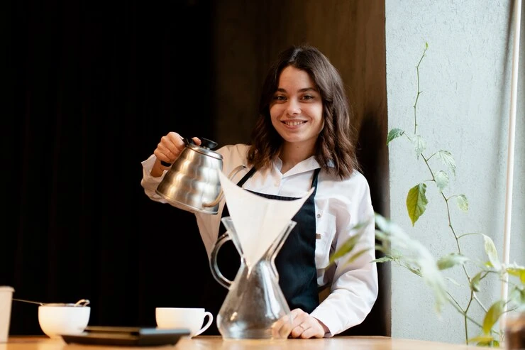 Pearl Lemon Cafe barista with a fresh pot of coffee